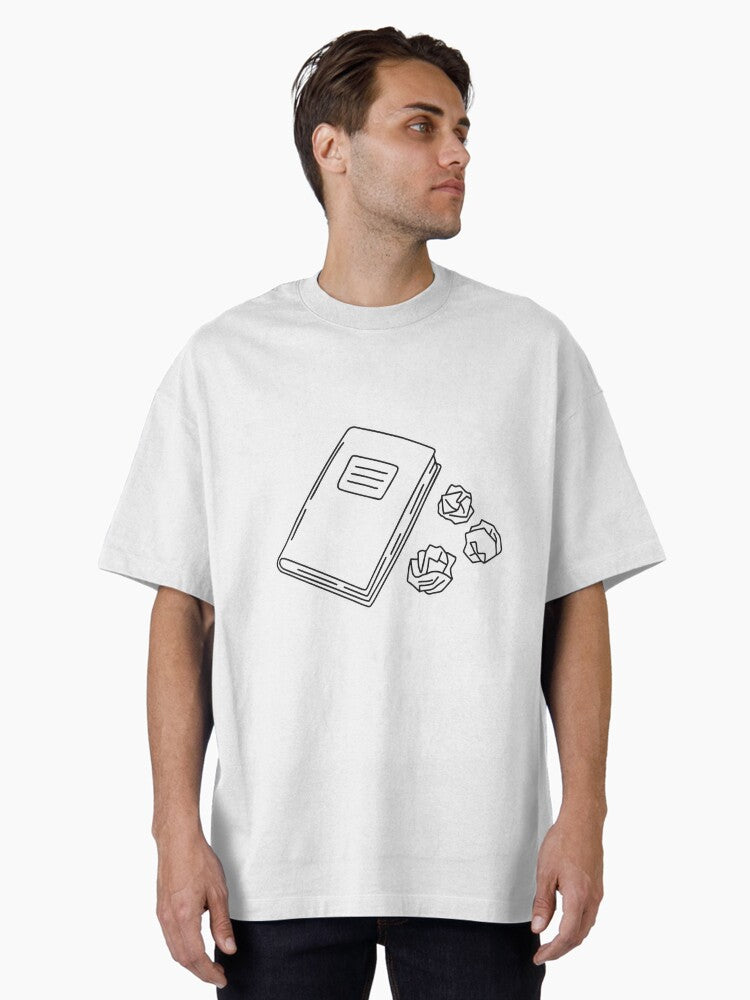 A Textbook Closed Beside A Three Crumpled Draft Papers Oversized T-shirt | Trendy Graphic Tee | Casual Unisex T-shirt